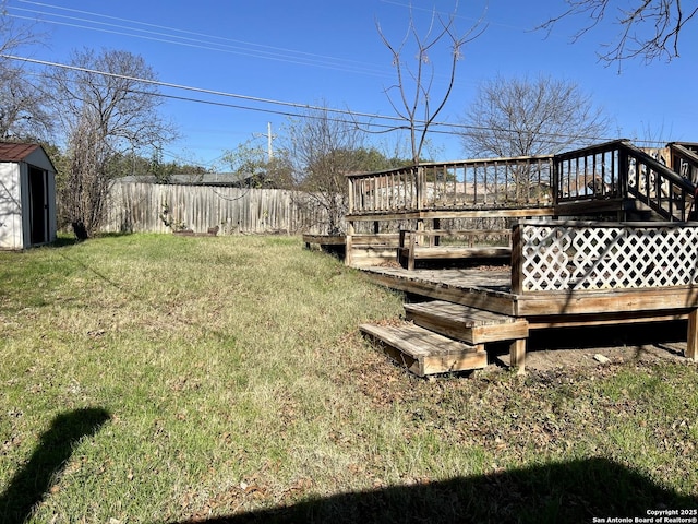 view of yard with a deck and a storage unit