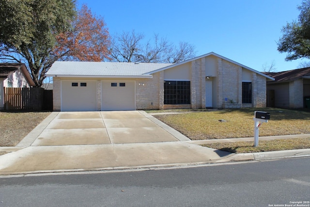 ranch-style home featuring a front lawn and a garage