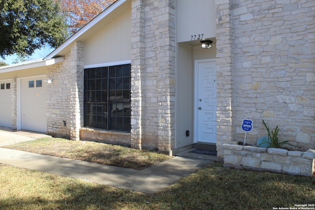 view of exterior entry featuring a garage