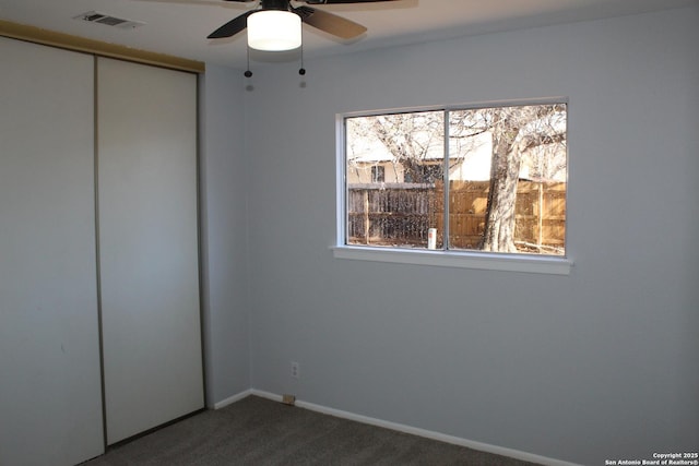 unfurnished bedroom with ceiling fan, a closet, and carpet flooring