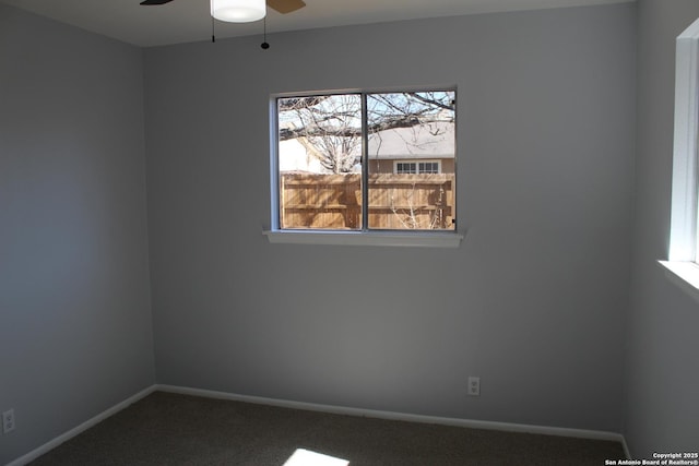 unfurnished room featuring ceiling fan and carpet flooring