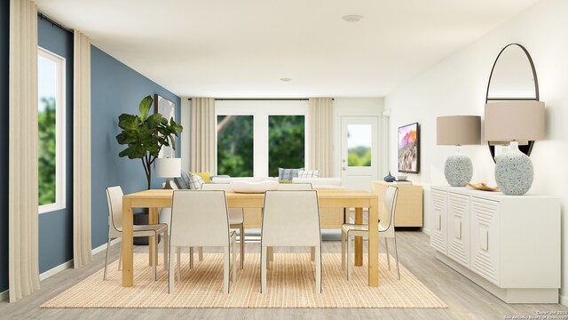 dining area featuring plenty of natural light and light hardwood / wood-style flooring