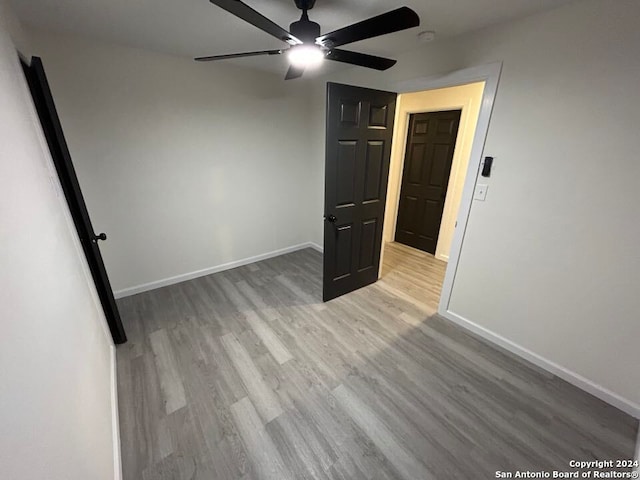 unfurnished bedroom featuring ceiling fan and light wood-type flooring