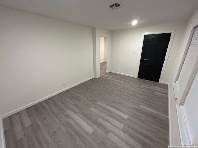 spare room with wood-type flooring