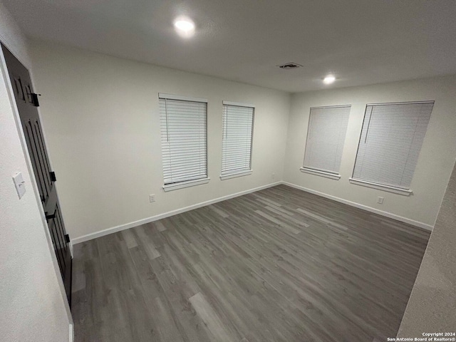 unfurnished room featuring dark wood-type flooring