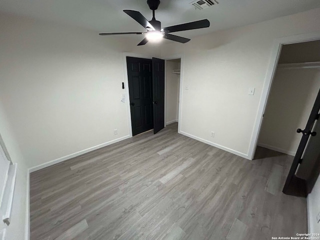 unfurnished bedroom featuring ceiling fan and light hardwood / wood-style flooring