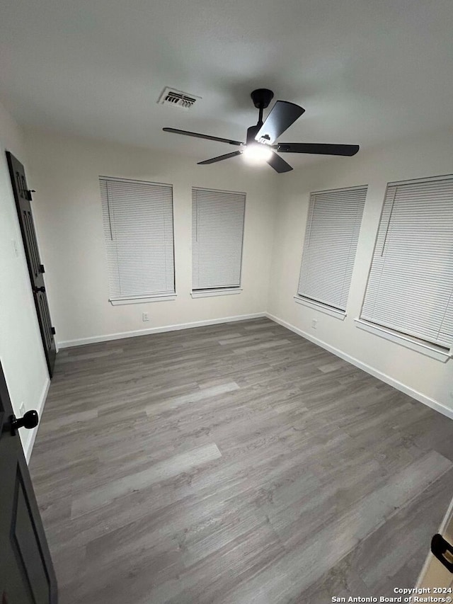 unfurnished bedroom featuring ceiling fan and hardwood / wood-style flooring