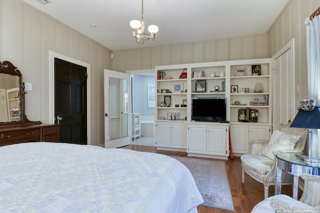 bedroom featuring an inviting chandelier and hardwood / wood-style floors