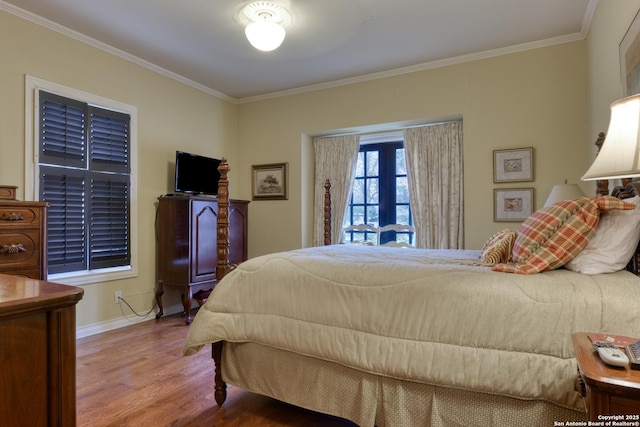 bedroom with crown molding and hardwood / wood-style floors