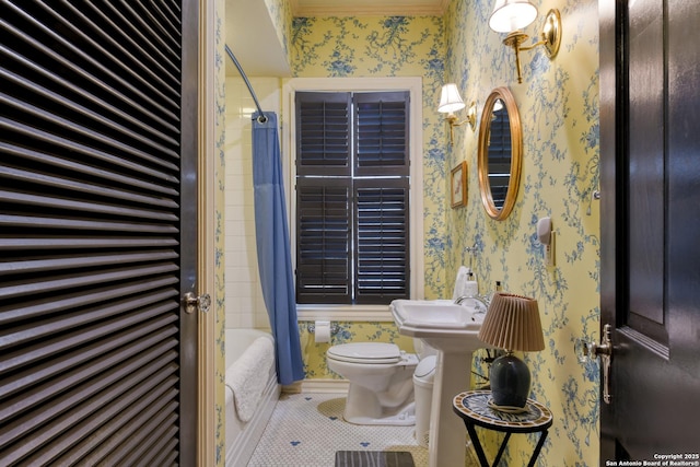 bathroom featuring shower / tub combo with curtain, toilet, and tile patterned flooring