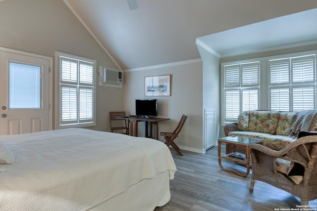 bedroom featuring hardwood / wood-style floors, ornamental molding, lofted ceiling, and a wall mounted AC