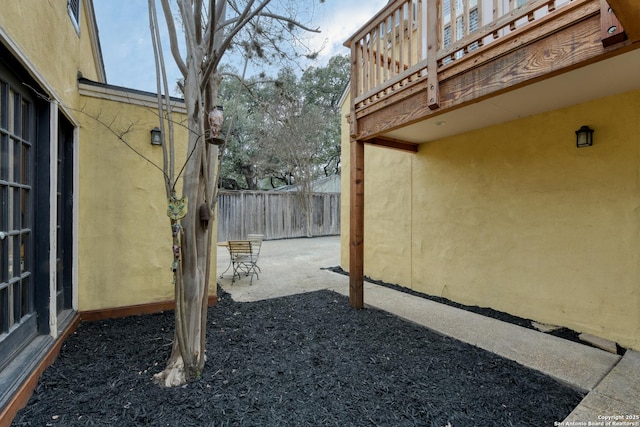 view of yard with a balcony and a patio area