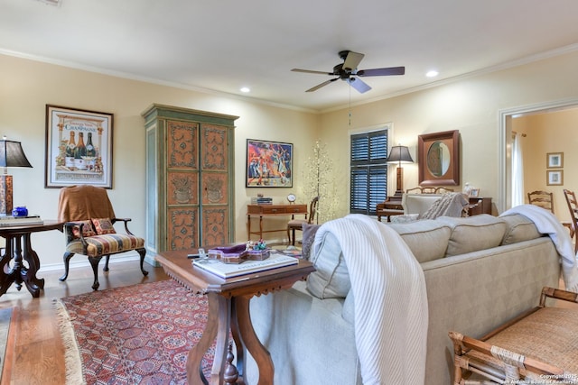 living room featuring crown molding, wood-type flooring, and ceiling fan