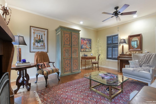 living room with hardwood / wood-style flooring, ornamental molding, and ceiling fan