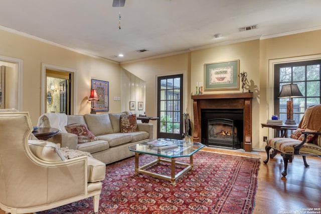 living room featuring hardwood / wood-style floors and ornamental molding