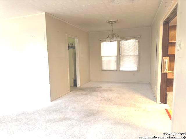 unfurnished room featuring light colored carpet