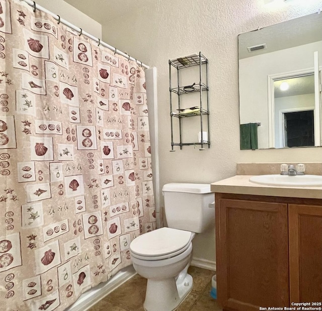 bathroom with toilet, vanity, a shower with curtain, and tile patterned flooring