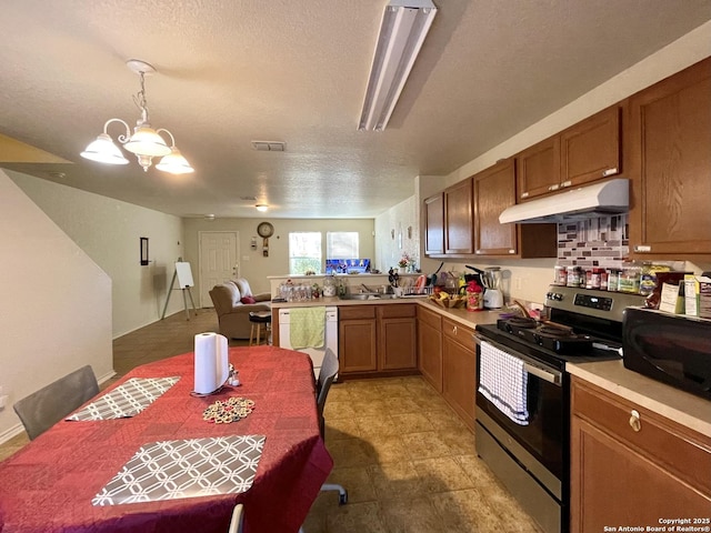 kitchen featuring decorative light fixtures, kitchen peninsula, stainless steel electric range oven, a notable chandelier, and white dishwasher