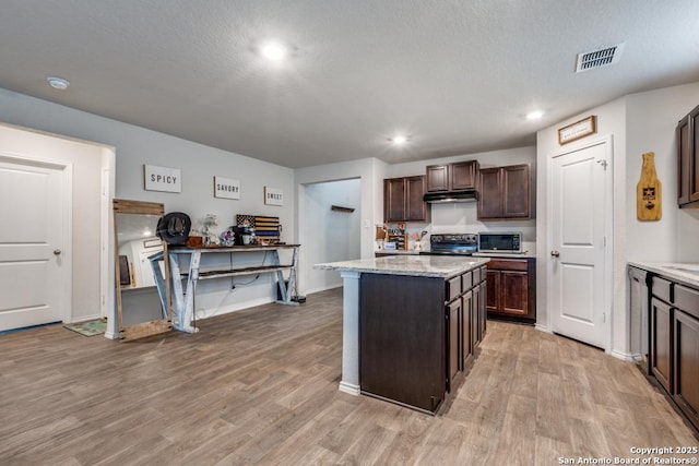 kitchen with a kitchen island, electric range, light hardwood / wood-style floors, and dark brown cabinetry