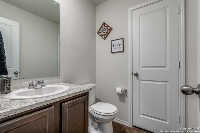 bathroom featuring toilet and vanity