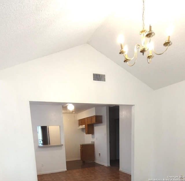 unfurnished living room with a chandelier and lofted ceiling