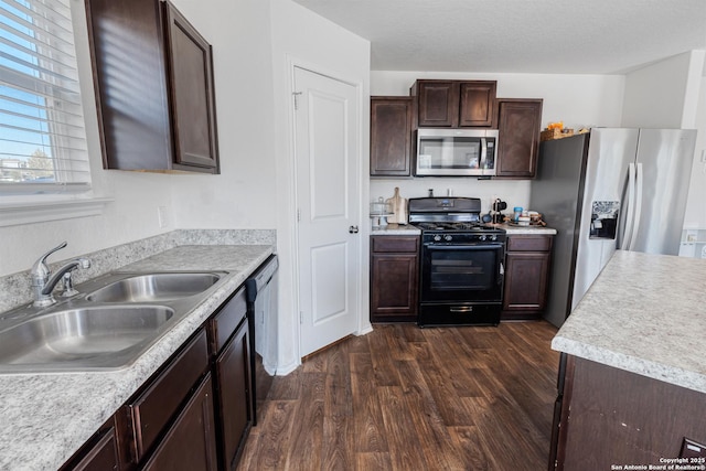 kitchen featuring black appliances, dark wood-type flooring, sink, and dark brown cabinetry