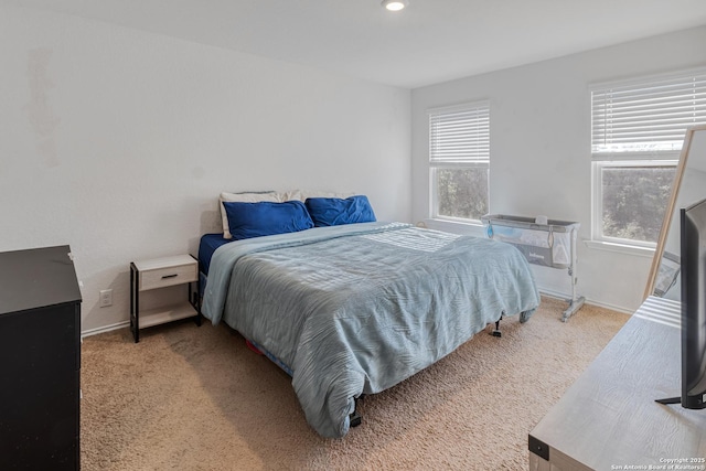 bedroom featuring light colored carpet