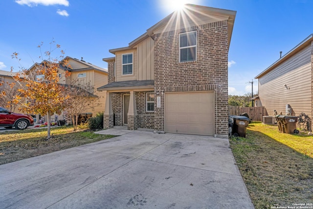 view of front of house with a garage, a front yard, and central AC