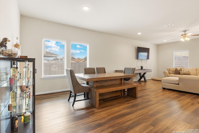 dining area featuring ceiling fan and dark hardwood / wood-style floors