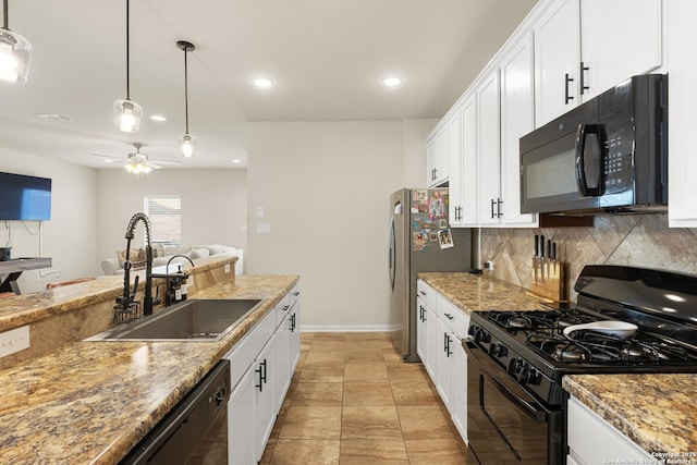 kitchen featuring ceiling fan, black appliances, pendant lighting, white cabinets, and sink
