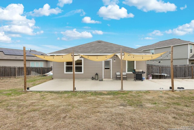 back of property featuring a patio area and a yard