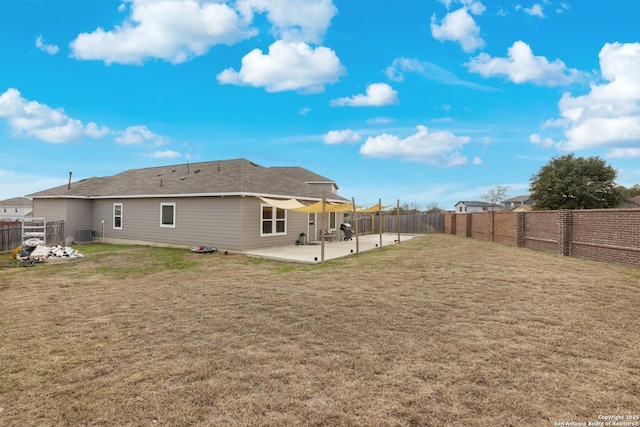 rear view of house featuring a lawn, central AC, and a patio