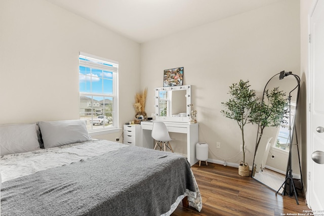 bedroom with dark wood-type flooring