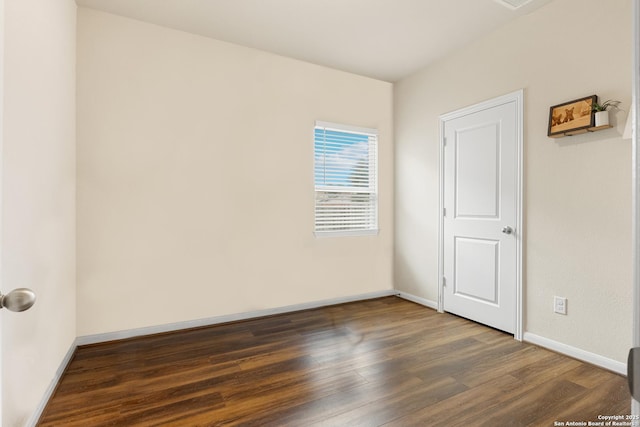 unfurnished room featuring dark hardwood / wood-style flooring