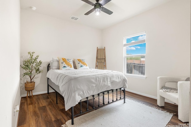 bedroom with ceiling fan and dark wood-type flooring