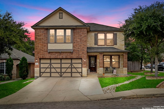 view of front of property with a lawn and a garage