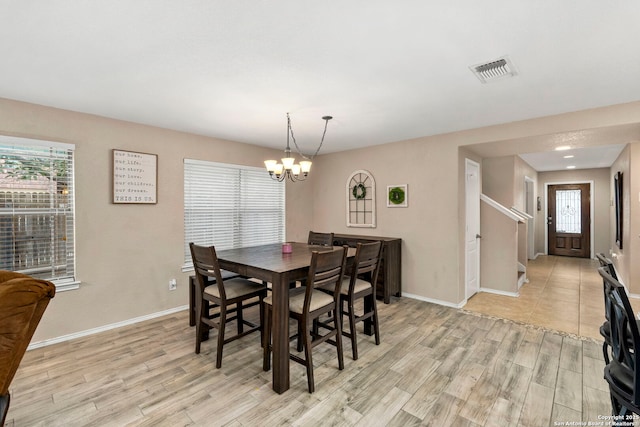 dining area featuring a chandelier and light hardwood / wood-style flooring