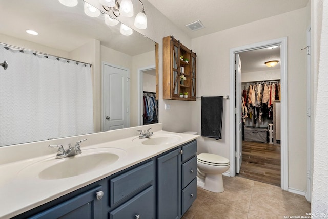 bathroom featuring tile patterned floors, toilet, and vanity