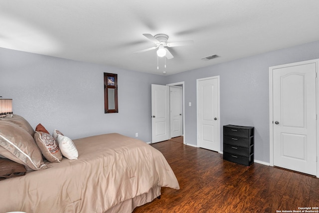 bedroom with ceiling fan and dark hardwood / wood-style floors