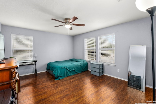 bedroom featuring ceiling fan and dark hardwood / wood-style floors