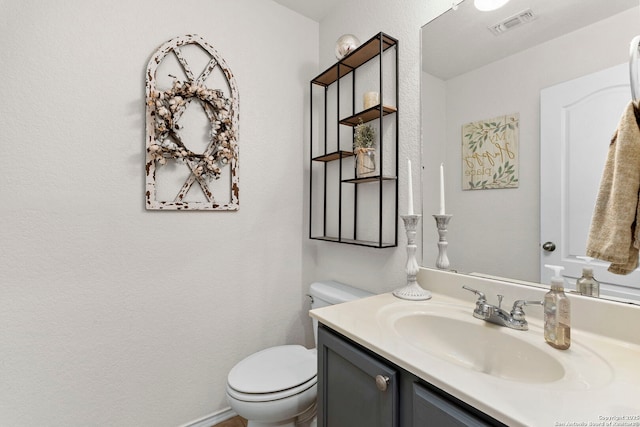 bathroom featuring toilet and vanity