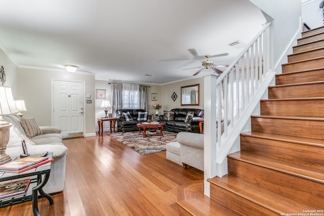 living room with ceiling fan, light hardwood / wood-style floors, and ornamental molding