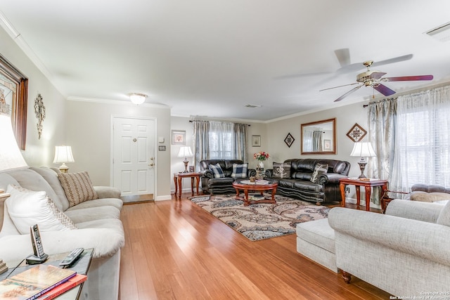 living room with ceiling fan, wood-type flooring, and crown molding