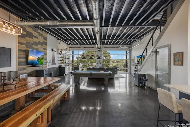 interior space with pool table and a high ceiling