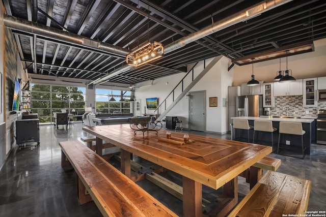 dining room featuring sink, billiards, and a high ceiling