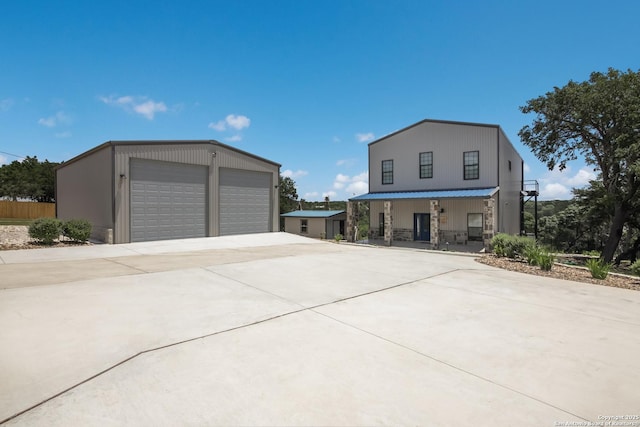 view of home's exterior featuring covered porch and a garage