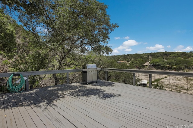 wooden terrace with a grill