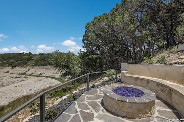 view of patio featuring an outdoor fire pit