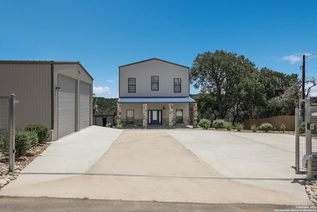 view of front of property featuring a garage and an outbuilding