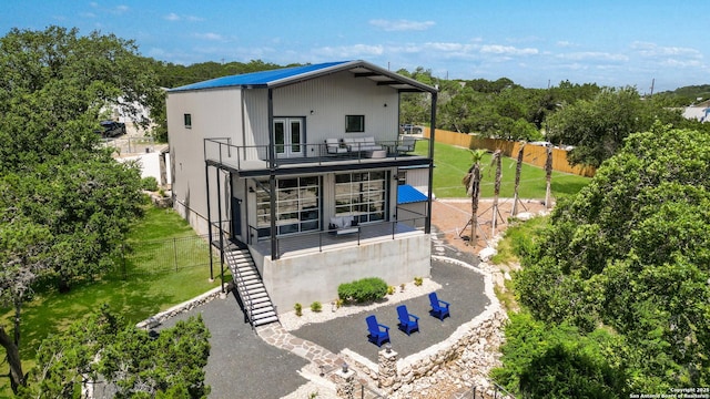 back of house featuring a balcony